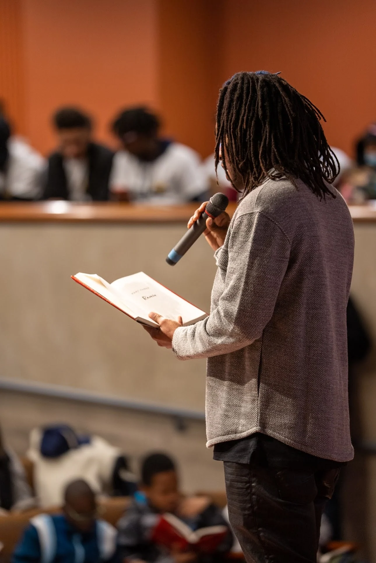 Nick Brooks reading to a student audience